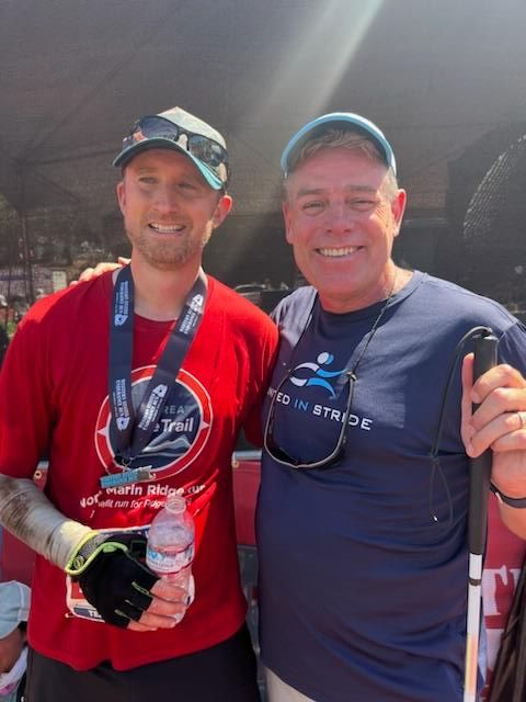 Blind ultramarathoner Will Barkan and United in Stride Founder smile at the finish line of the Western States 100 race.